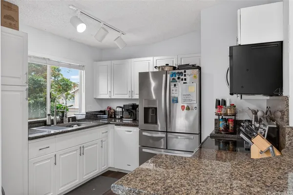 a kitchen with refrigerator and sink
