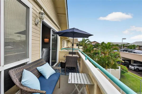 a balcony view with a seating space