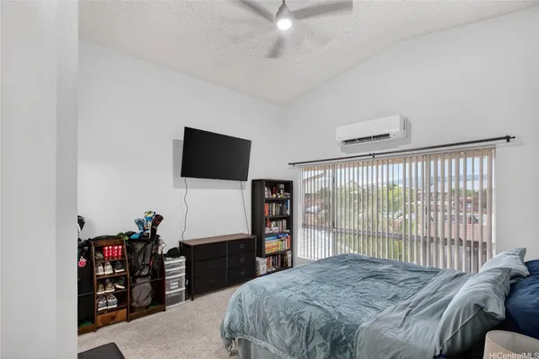 a bedroom with a bed and a flat tv screen