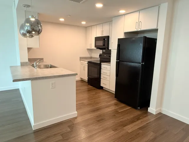 a kitchen with stainless steel appliances a refrigerator and a sink