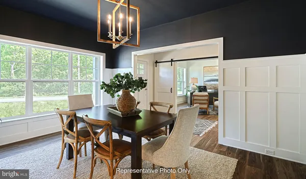 a view of a dining room with furniture wooden floor and chandelier