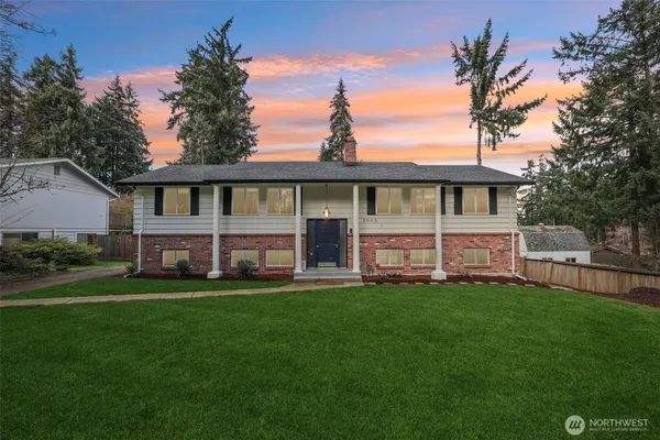 a view of a house with a yard and sitting area