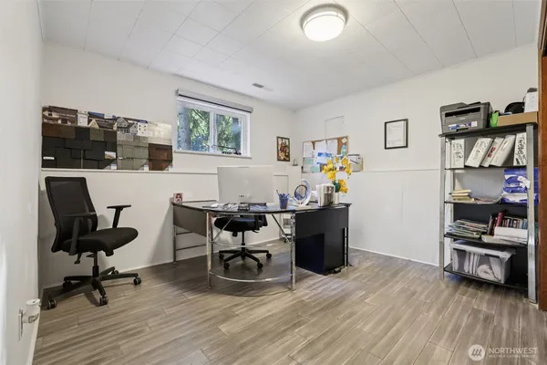 a view of a workspace with furniture and a window