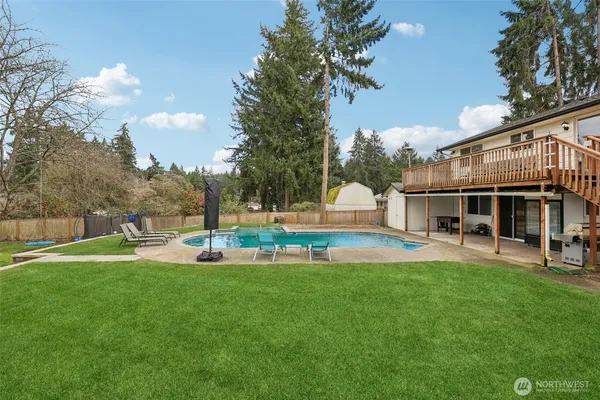 a view of a house with a backyard and sitting area