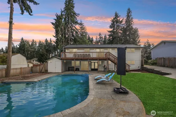 a view of a house with backyard and sitting area