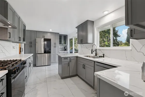a kitchen with a sink appliances and cabinets