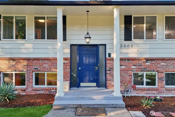 front view of a brick house with a large window