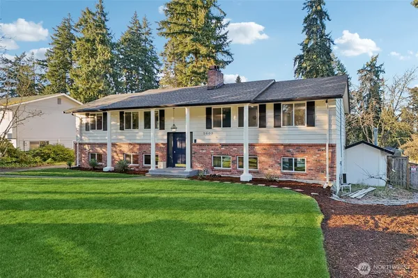 a front view of a house with a garden and plants