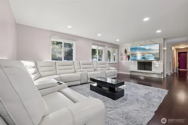 a living room with furniture and a wooden floor