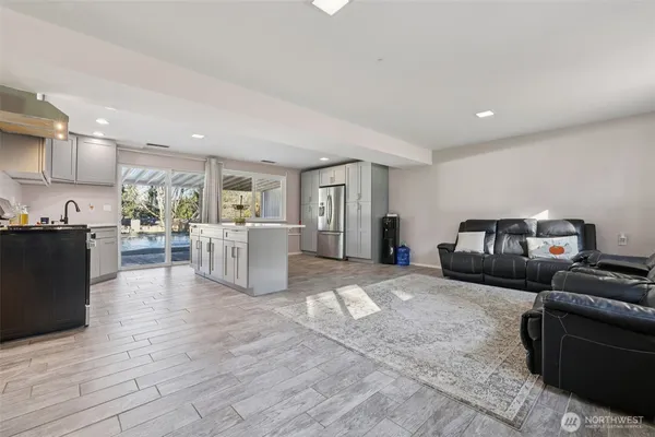 a living room with furniture and kitchen view