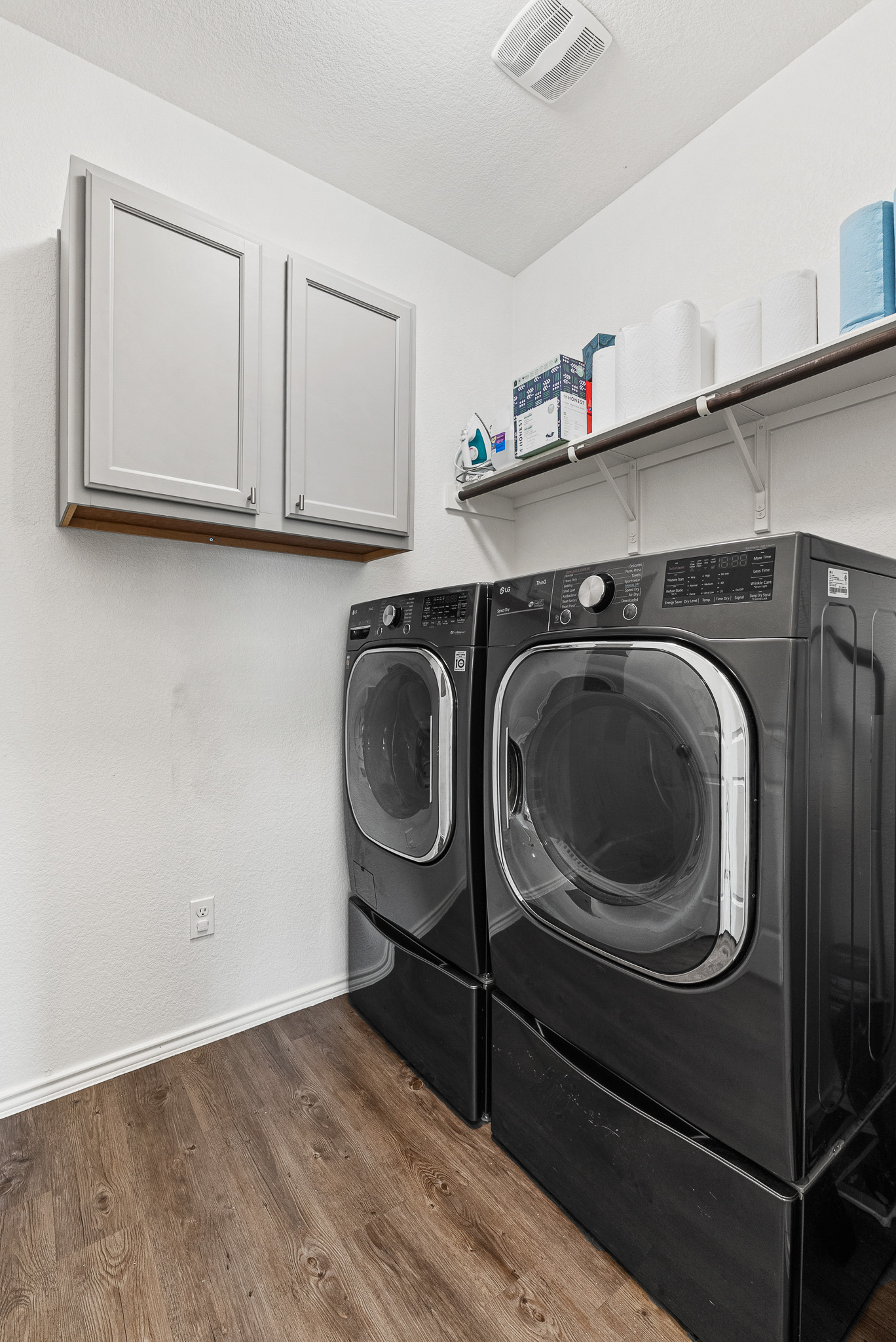 136 Copper Lane Kyle, TX 78640 - Photo 14 of 33 Laundry room featuring dark wood-style floors, independent washer and dryer, cabinet space, and a textured ceiling