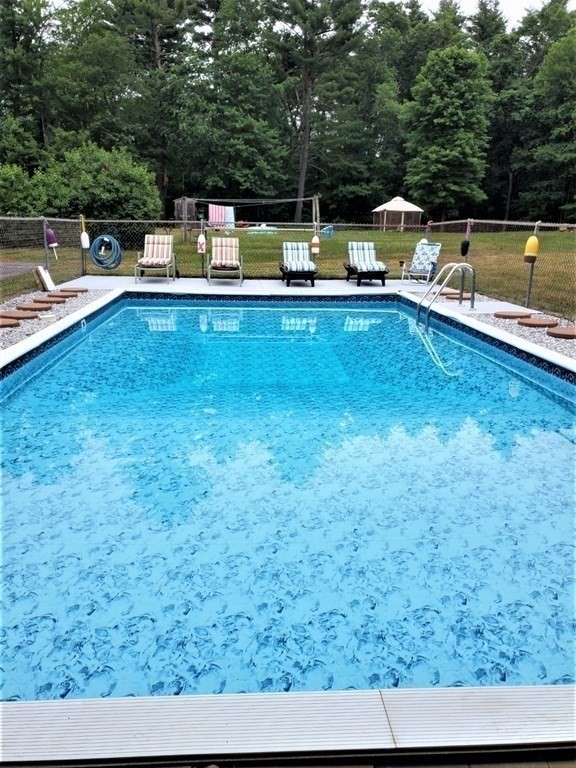 204 New Boston Road Sturbridge, MA 01566 - Photo 5 of 26 a view of a swimming pool with a patio and a yard