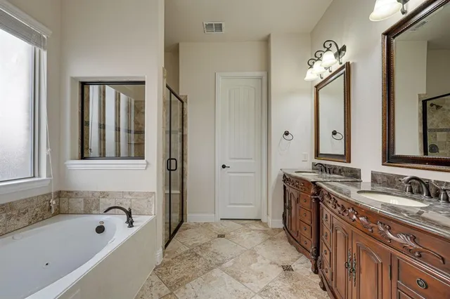 a bathroom with a tub sink and mirror