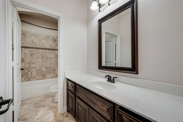 a bathroom with a sink a vanity and a mirror