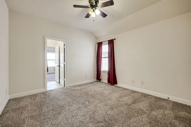 a view of an empty room with a ceiling fan