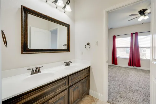 a bathroom with a sink vanity and a mirror