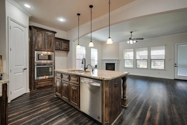 a kitchen with stainless steel appliances granite countertop a stove and cabinets