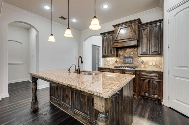a kitchen with center island table and chairs in it