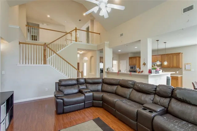 a living room with furniture and wooden floor