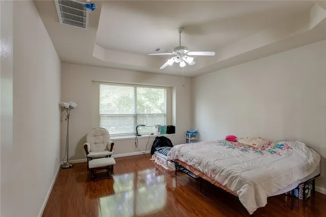 a bed room with a bed and a chandelier