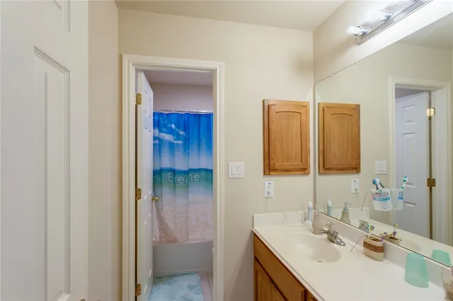 a bathroom with a sink vanity and mirror