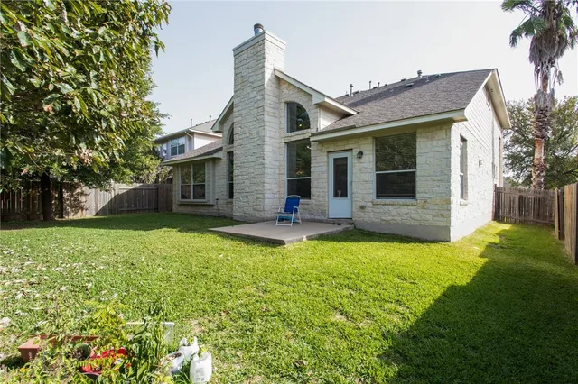 a view of a house with pool and garden