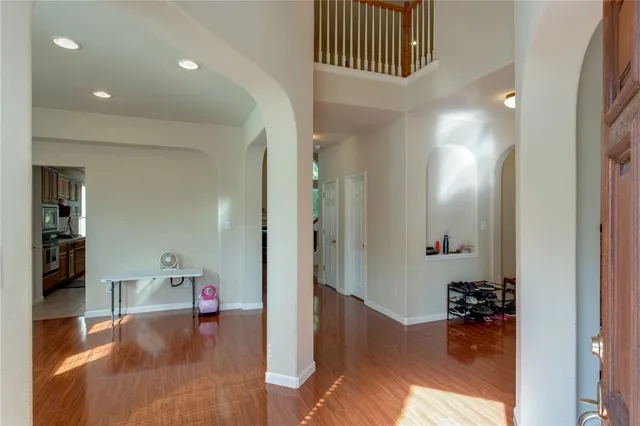 a view of a hallway and livingroom with furniture