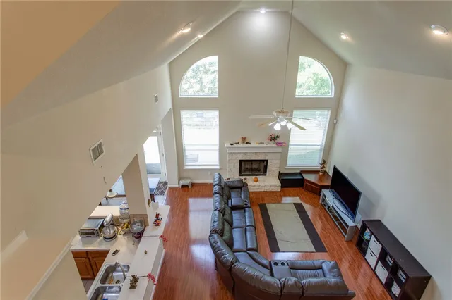 a living room with fireplace furniture and a potted plant