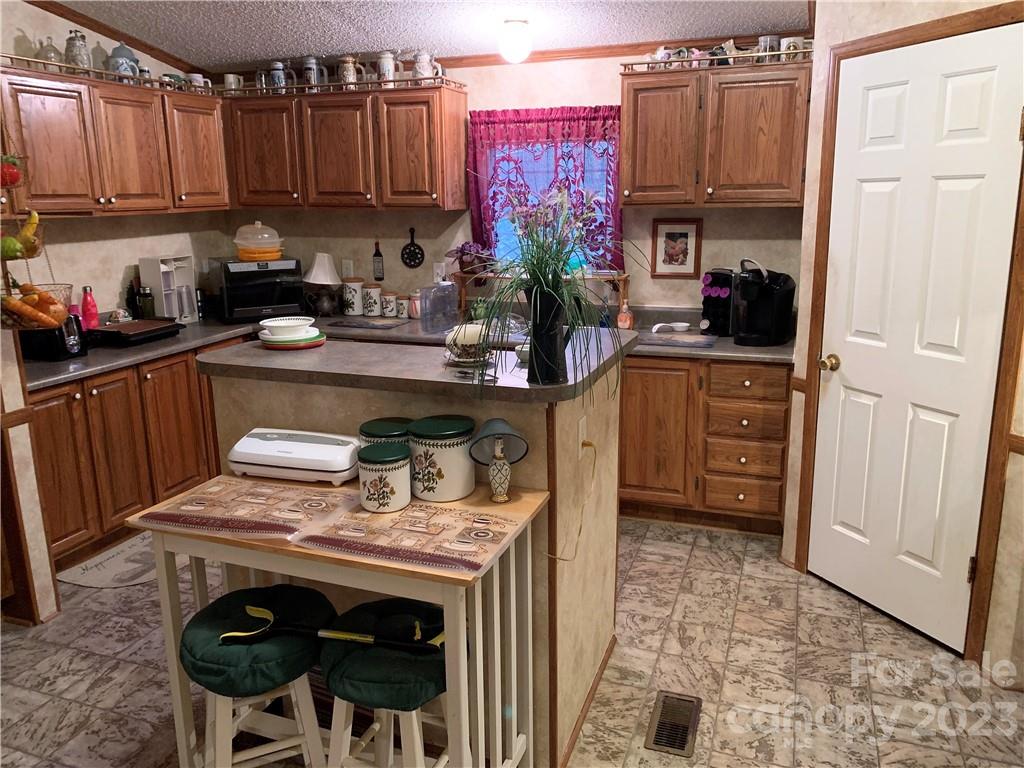 123 Beech Tree Lane Rutherfordton, NC 28139 - Photo 14 of 48 a kitchen with stainless steel appliances granite countertop a stove a sink and a refrigerator
