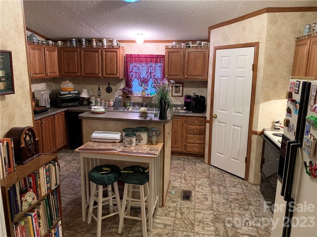 123 Beech Tree Lane Rutherfordton, NC 28139 - Photo 15 of 48 a kitchen with granite countertop a stove a sink and a refrigerator