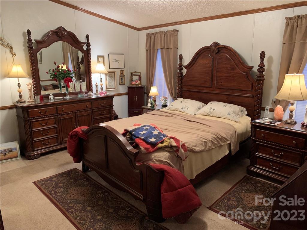 123 Beech Tree Lane Rutherfordton, NC 28139 - Photo 19 of 48 a bedroom with a bed and a mirror on dresser