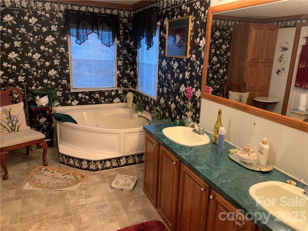 123 Beech Tree Lane Rutherfordton, NC 28139 - Photo 22 of 48 a bathroom with a granite countertop sink and a mirror