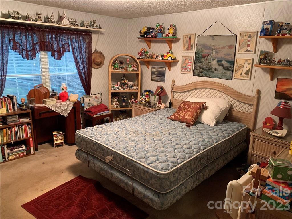 123 Beech Tree Lane Rutherfordton, NC 28139 - Photo 28 of 48 a bed sitting in a bedroom next to a window