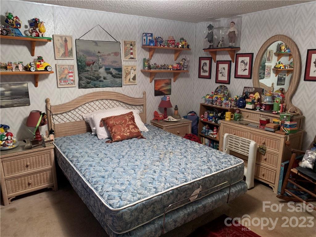 123 Beech Tree Lane Rutherfordton, NC 28139 - Photo 29 of 48 a bedroom with a bed and dresser