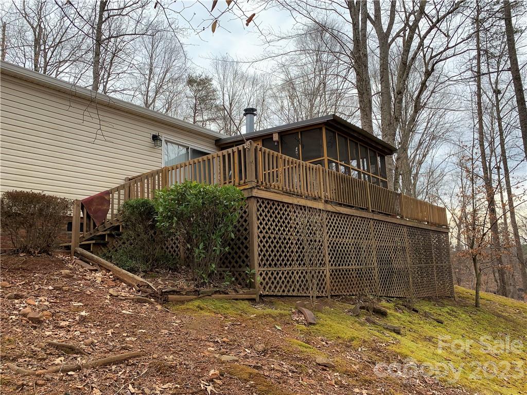 123 Beech Tree Lane Rutherfordton, NC 28139 - Photo 3 of 48 a view of a house with a large tree and wooden fence