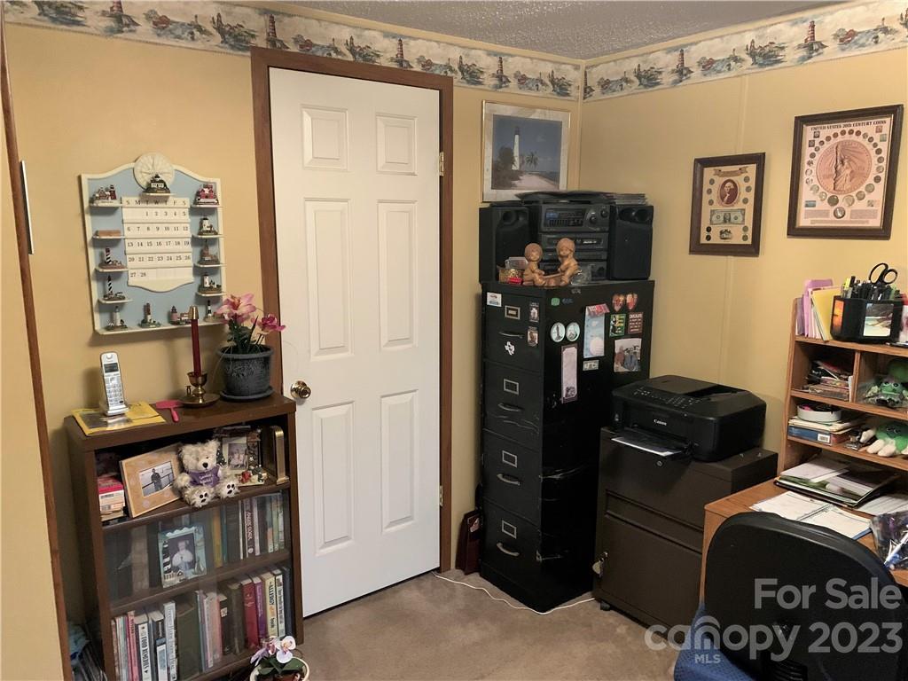 123 Beech Tree Lane Rutherfordton, NC 28139 - Photo 33 of 48 a living room with furniture and a book shelf
