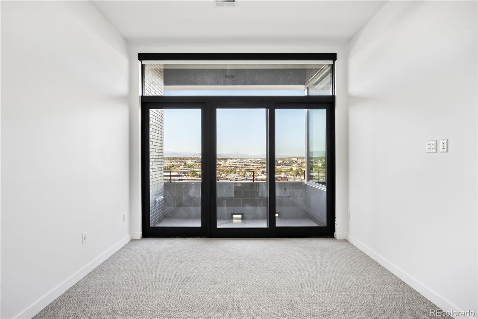 3520 Chestnut Place, Unit PH1202 Denver, CO 80216 - Photo 18 of 41 an empty room with large window