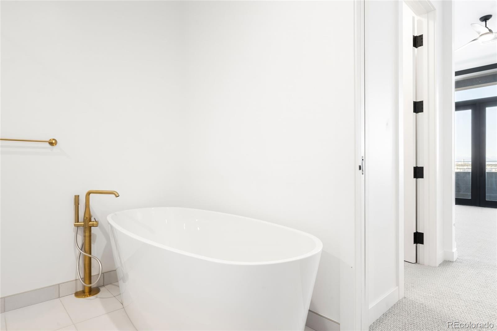 3520 Chestnut Place, Unit PH1202 Denver, CO 80216 - Photo 22 of 41 a white bath tub sitting in a bathroom