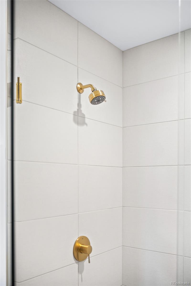 3520 Chestnut Place, Unit PH1202 Denver, CO 80216 - Photo 23 of 41 a bathroom with a shower