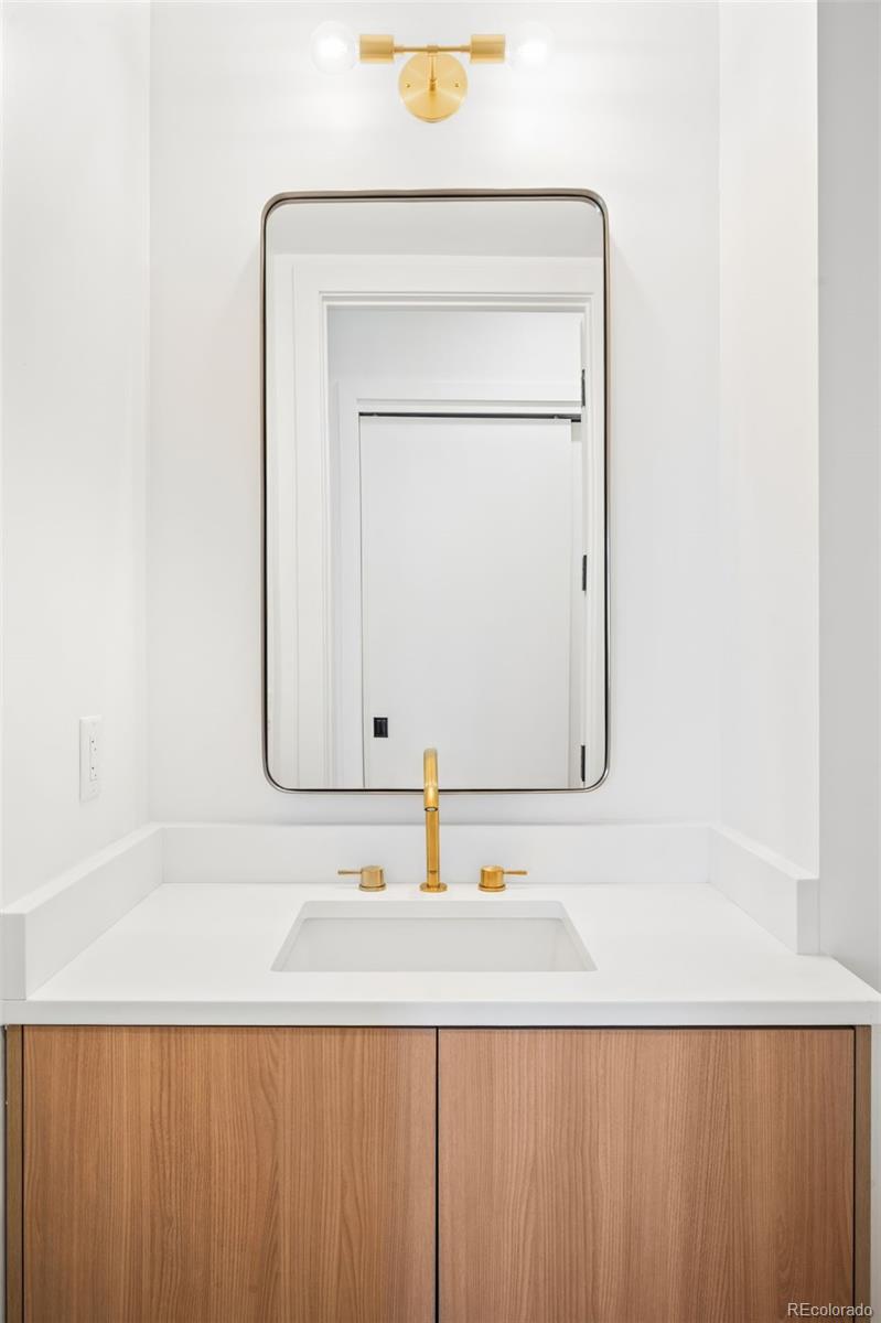 3520 Chestnut Place, Unit PH1202 Denver, CO 80216 - Photo 27 of 41 a bathroom with a sink vanity and a mirror