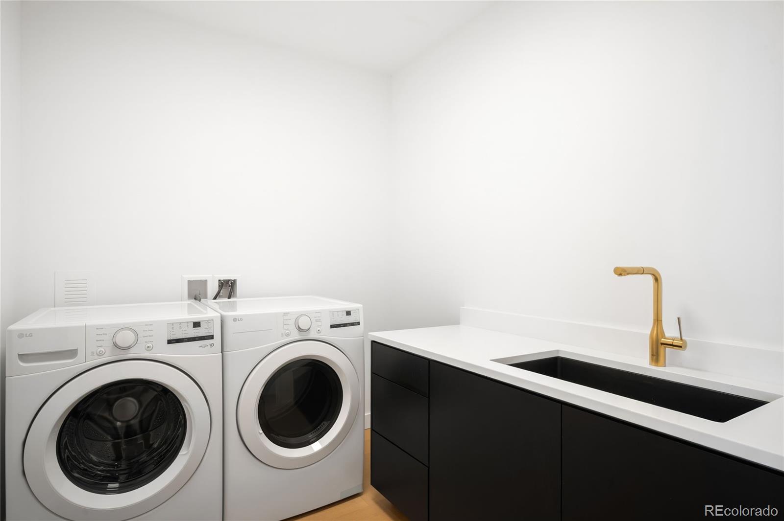 3520 Chestnut Place, Unit PH1202 Denver, CO 80216 - Photo 28 of 41 a utility room with dryer and washer