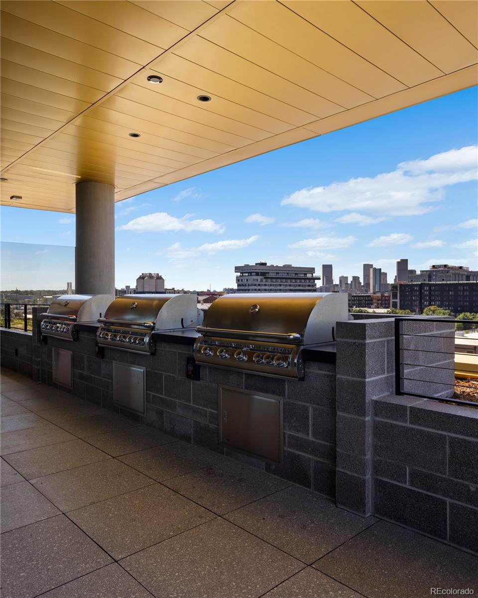 3520 Chestnut Place, Unit PH1202 Denver, CO 80216 - Photo 36 of 41 a kitchen with stainless steel appliances granite countertop a stove and a oven
