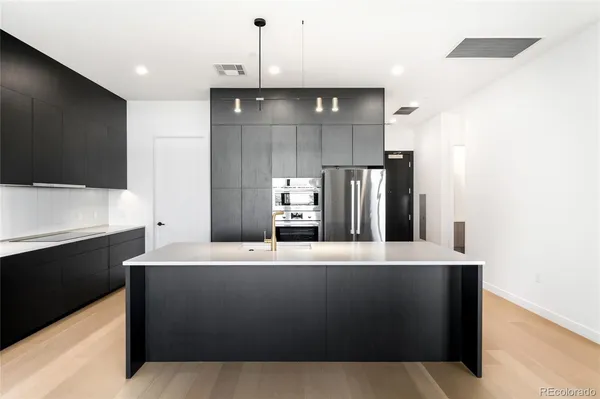 a kitchen with stainless steel appliances a sink and stove top oven