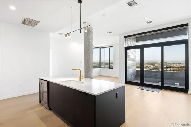 a large kitchen with a refrigerator and a sink