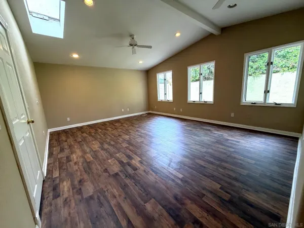 a view of an empty room and wooden floor