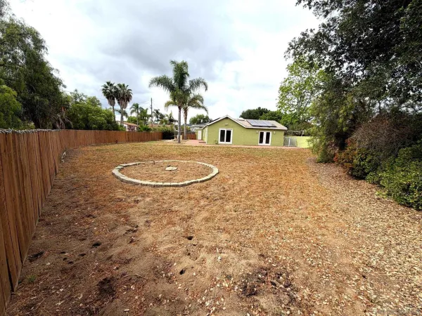 a view of a yard with potted plants