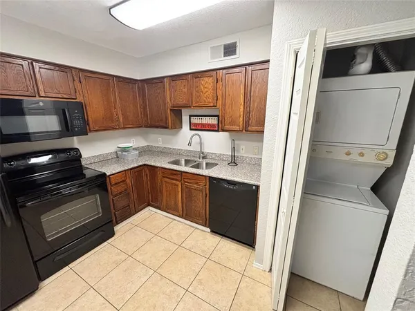 a kitchen with a sink stove and refrigerator