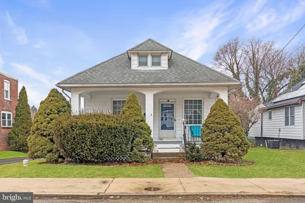 a living room with furniture windows and wooden floor
