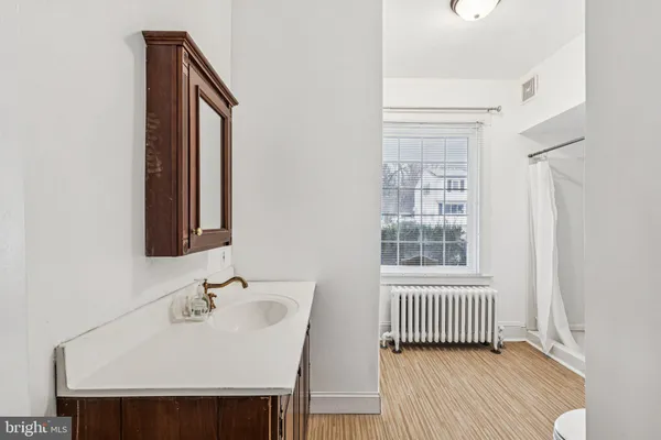 a view of a room with wooden floor and white walls