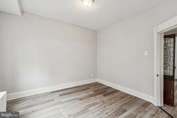 a view of a hallway with white walls and stairs